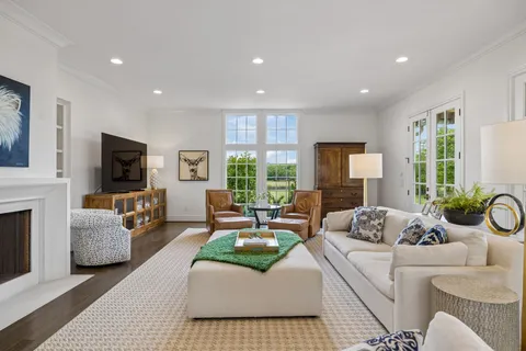 a living room with furniture fireplace and flat screen tv