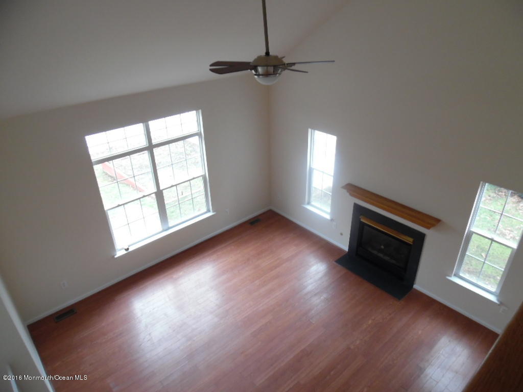 125 Swordfish Road Manahawkin, NJ 08050 - Photo 2 of 15 wooden floor in an empty room with a window