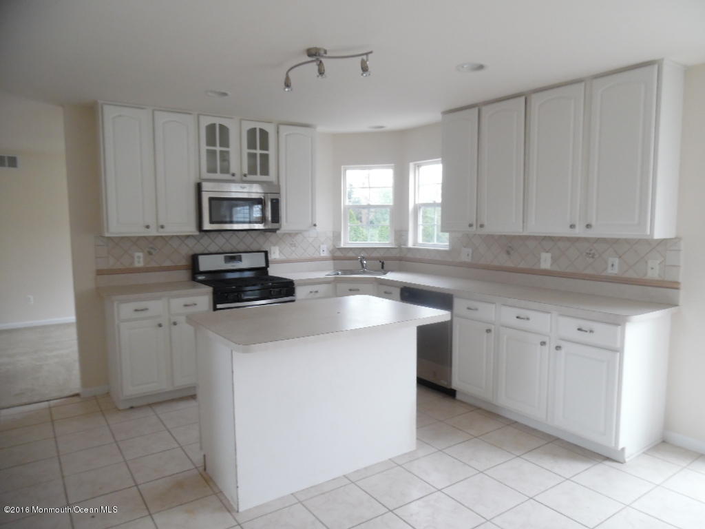 125 Swordfish Road Manahawkin, NJ 08050 - Photo 4 of 15 a kitchen with cabinets appliances a sink and a window
