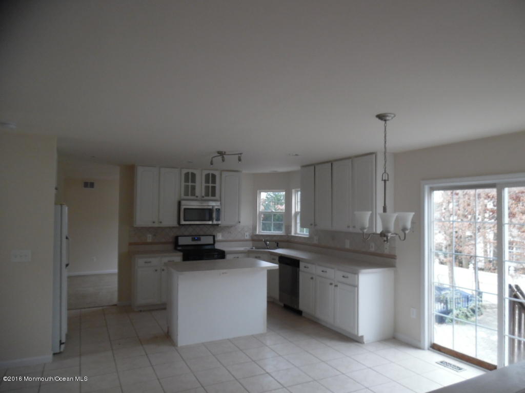 125 Swordfish Road Manahawkin, NJ 08050 - Photo 5 of 15 a kitchen with stainless steel appliances granite countertop a stove a sink and a refrigerator