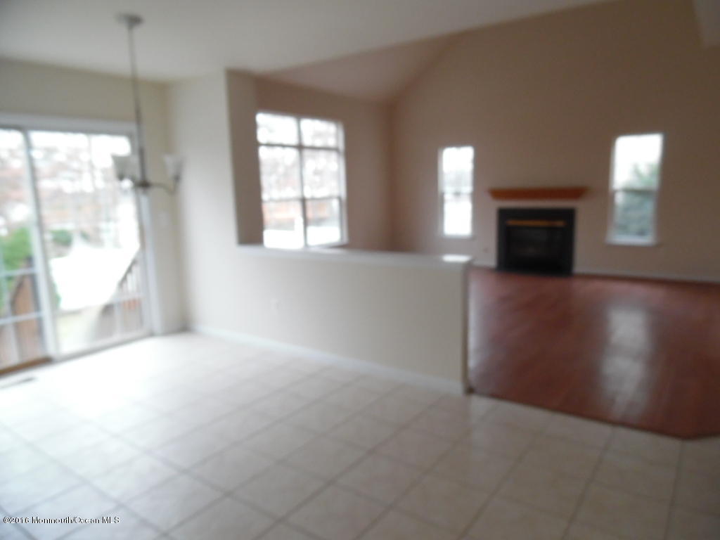 125 Swordfish Road Manahawkin, NJ 08050 - Photo 6 of 15 an empty room with windows and fireplace