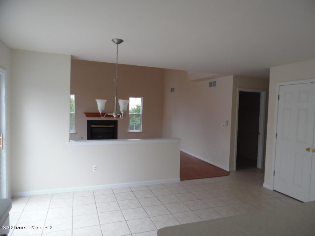 125 Swordfish Road Manahawkin, NJ 08050 - Photo 7 of 15 a living room with furniture and a fireplace