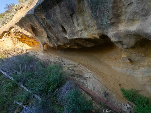 a living room with patio furniture and a fireplace