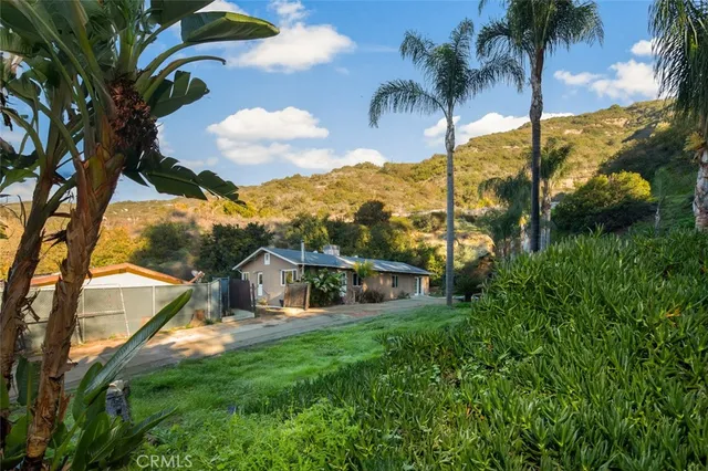 a view of a house with a backyard and a patio