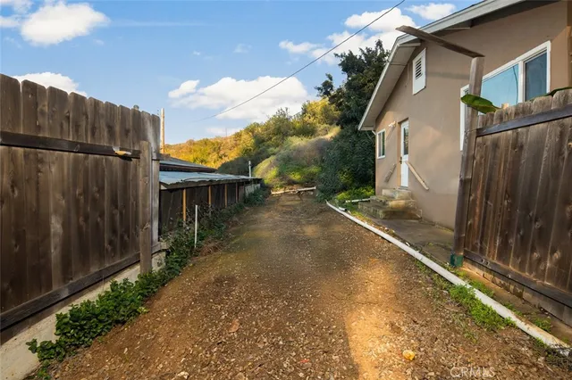 an aerial view of a house with yard and trees