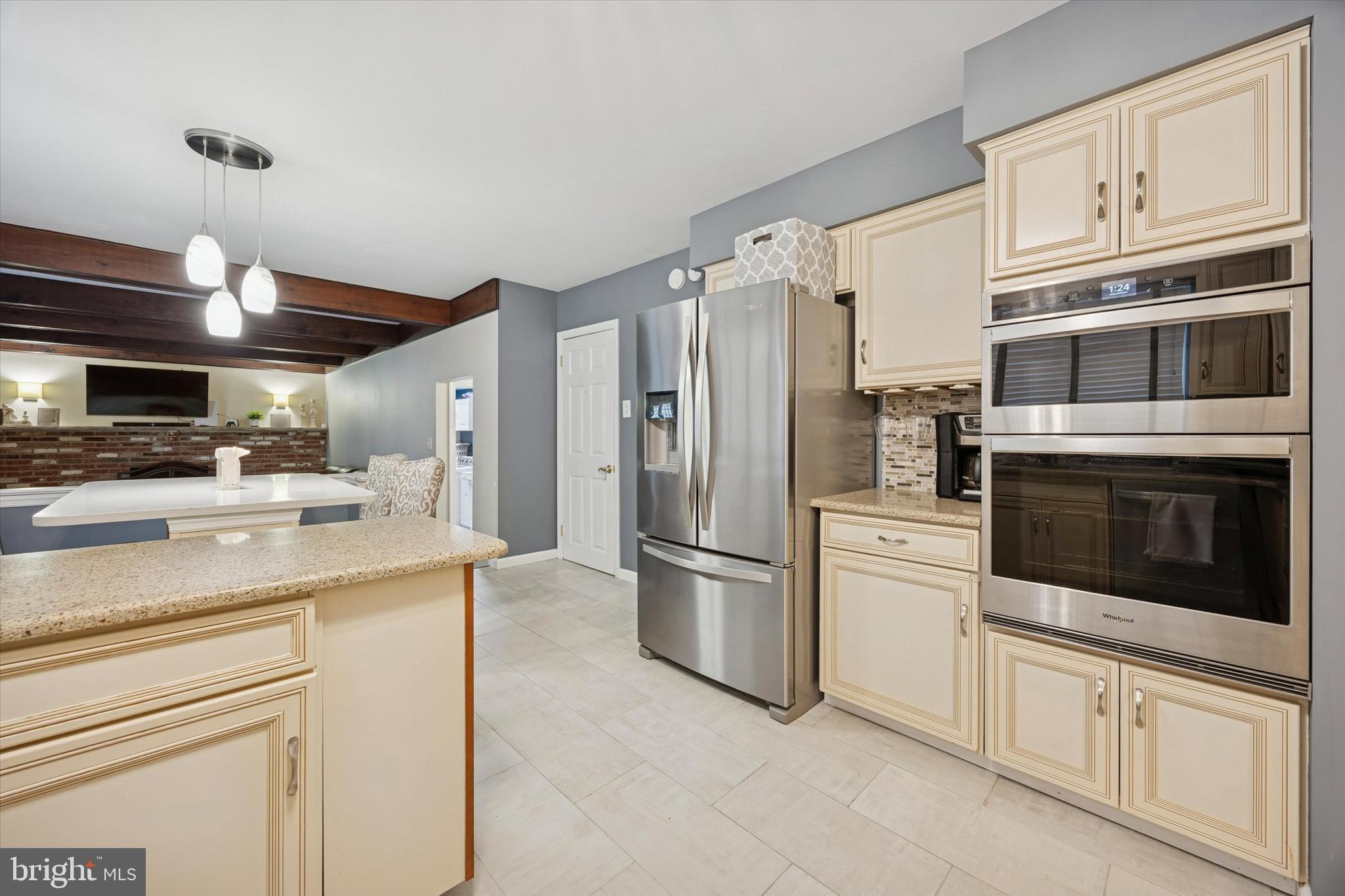 740 Grant Road Mount Laurel, NJ 08054 - Photo 12 of 35 a kitchen with stainless steel appliances a stove a microwave and a refrigerator