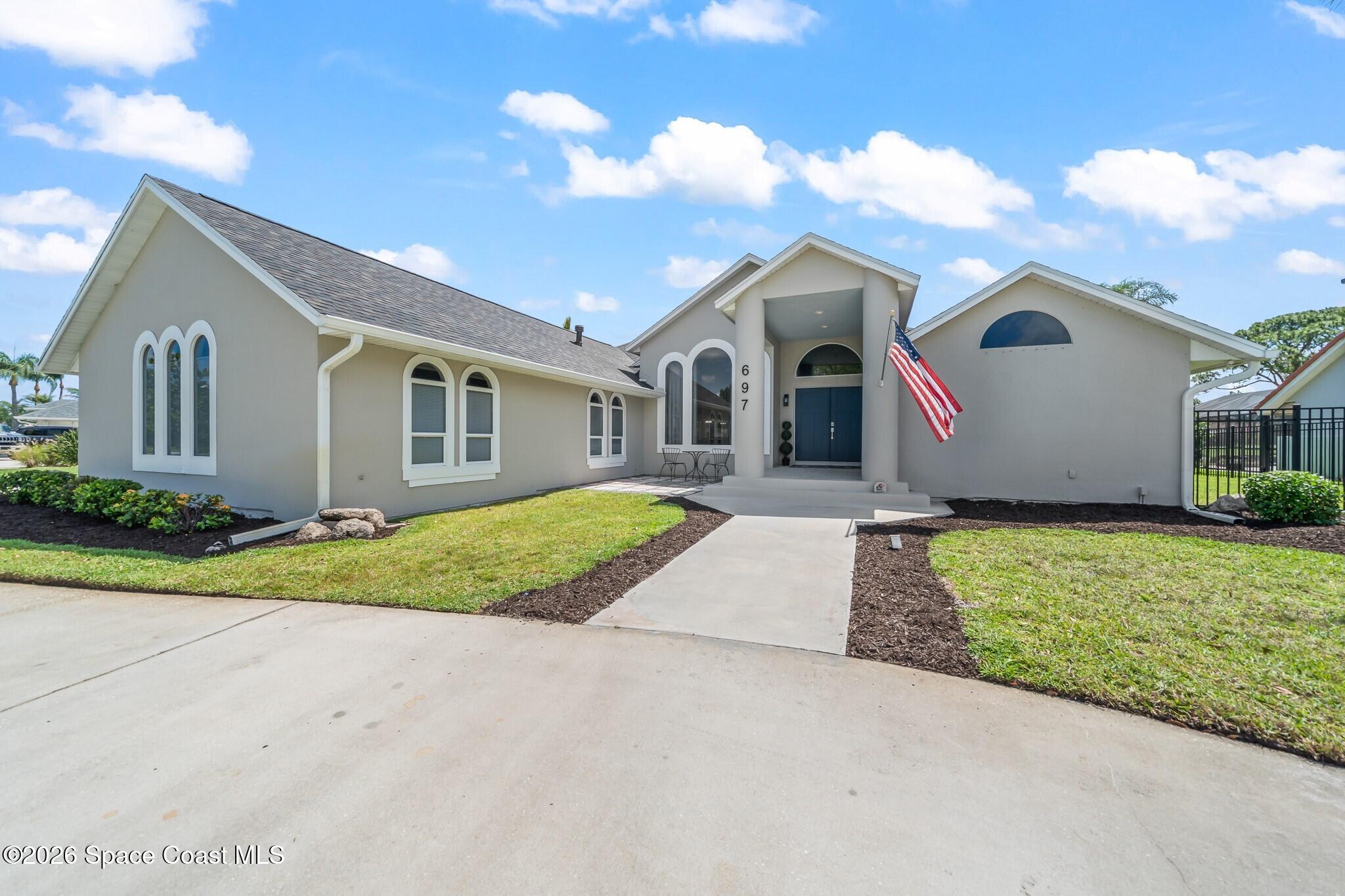 697 Spring Lake Drive Melbourne, FL 32940 - Photo 6 of 45 a front view of house with yard and green space