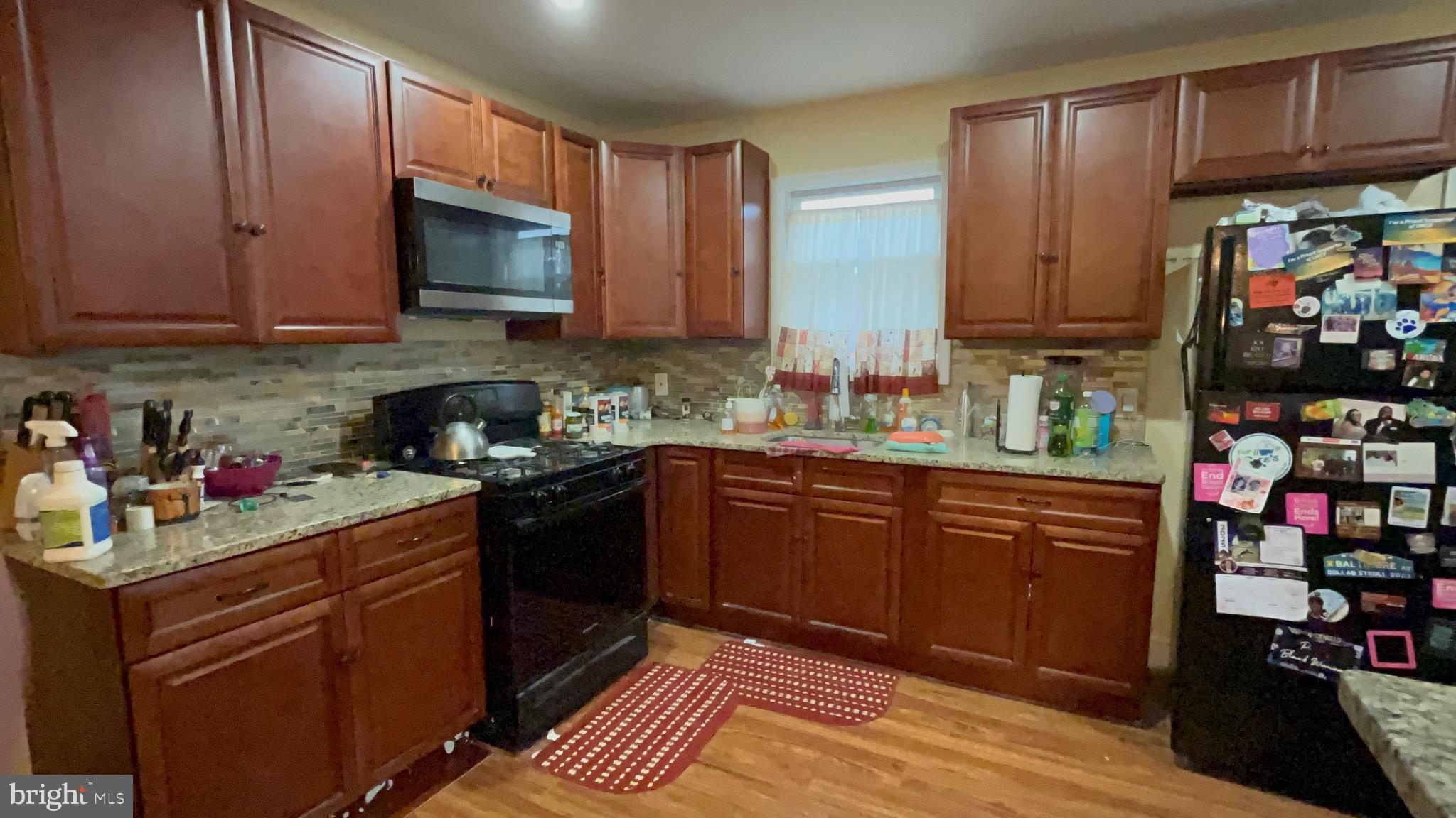 800 Bullock Avenue Lansdowne, PA 19050 - Photo 4 of 19 a kitchen with stainless steel appliances granite countertop a stove sink microwave and cabinets