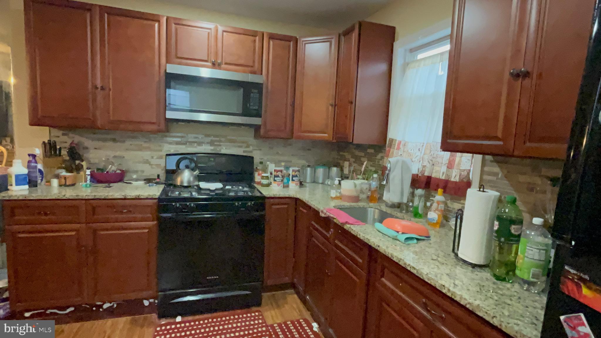 800 Bullock Avenue Lansdowne, PA 19050 - Photo 5 of 19 a kitchen with stainless steel appliances granite countertop a stove a sink and a microwave