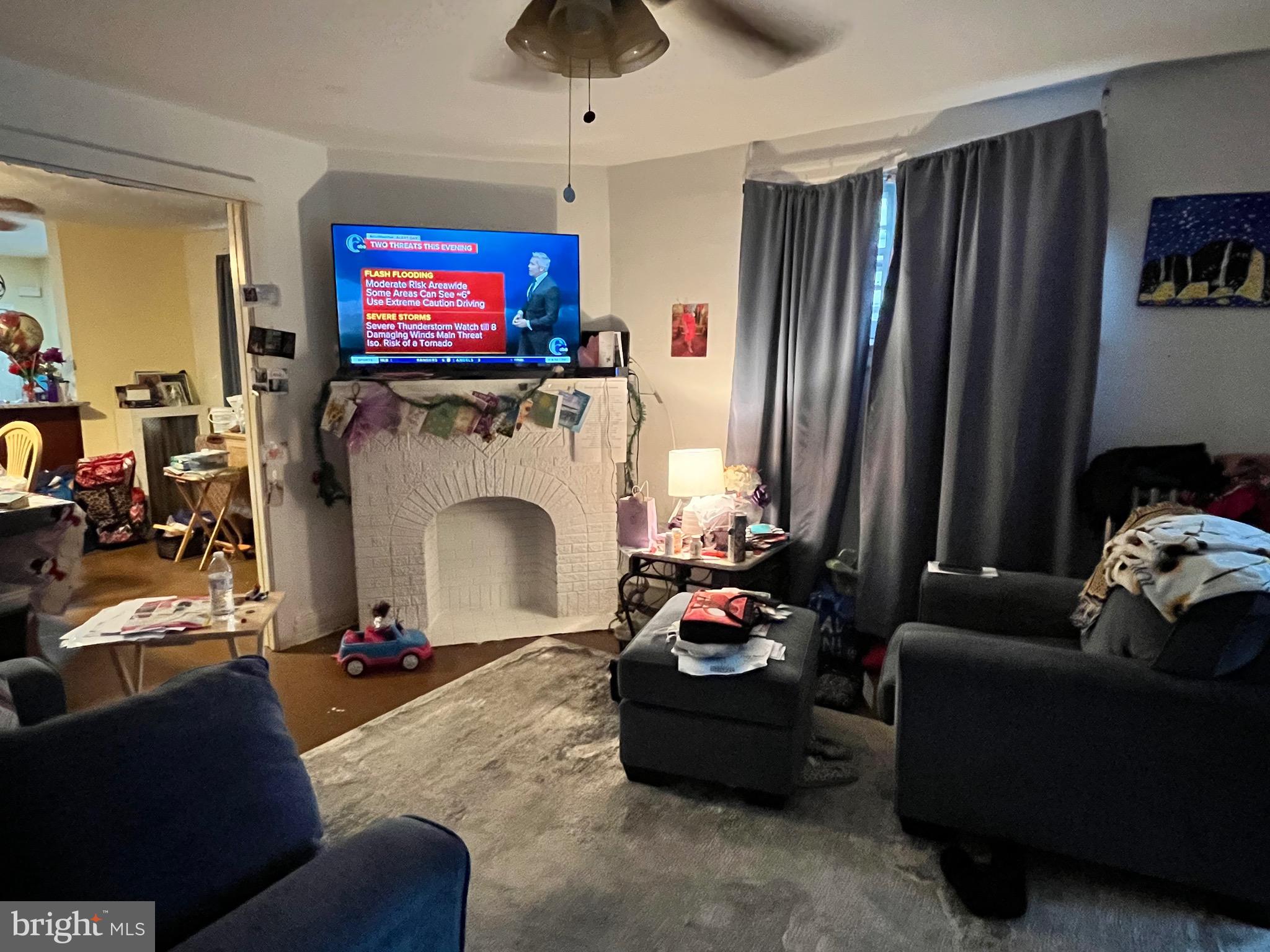 800 Bullock Avenue Lansdowne, PA 19050 - Photo 8 of 19 a living room with furniture a fireplace and a flat screen tv