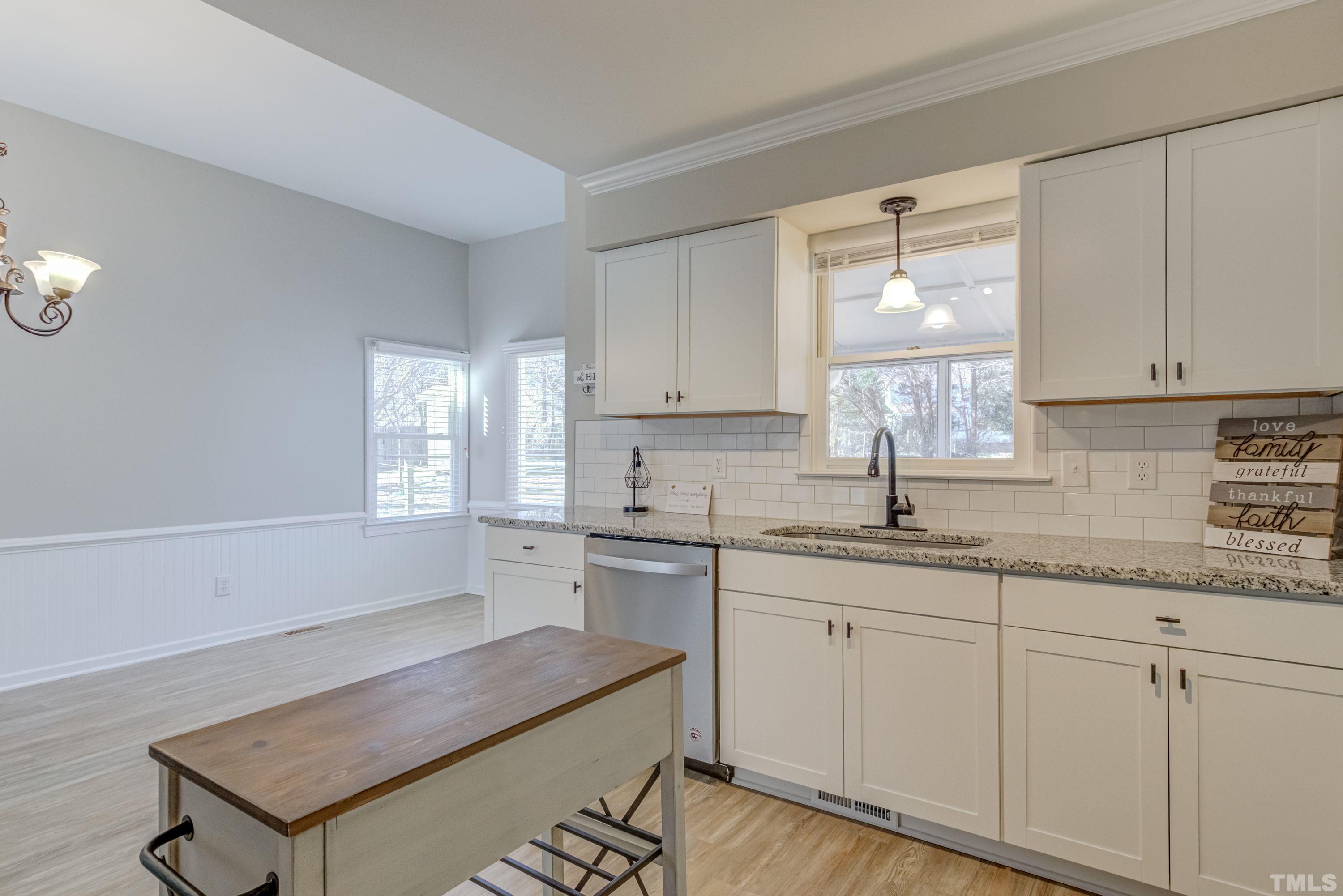 9305 Tallgrass Road Raleigh, NC 27603 - Photo 16 of 49 a kitchen with a sink cabinets and window