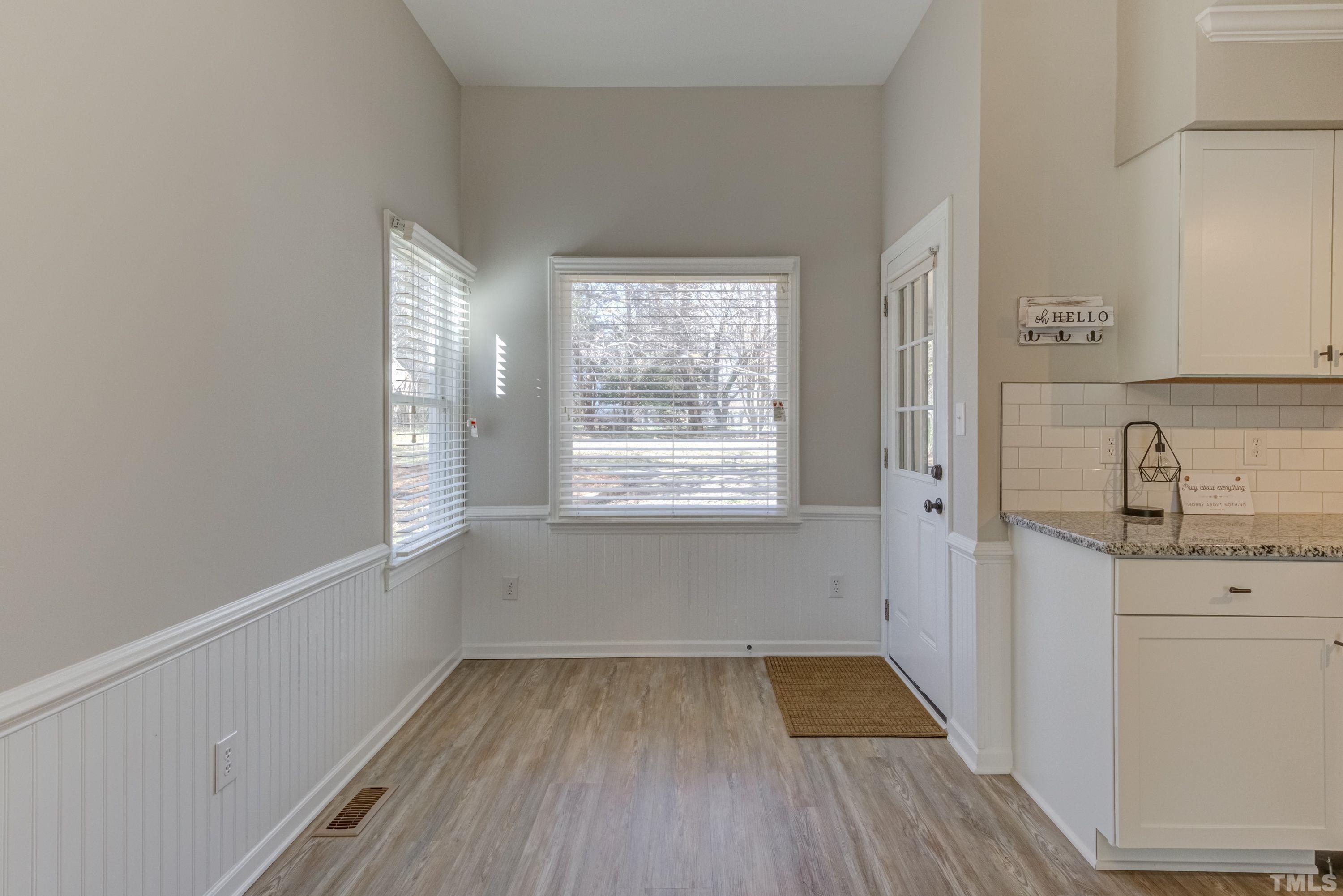 9305 Tallgrass Road Raleigh, NC 27603 - Photo 17 of 49 a view of empty room with wooden floor and fan