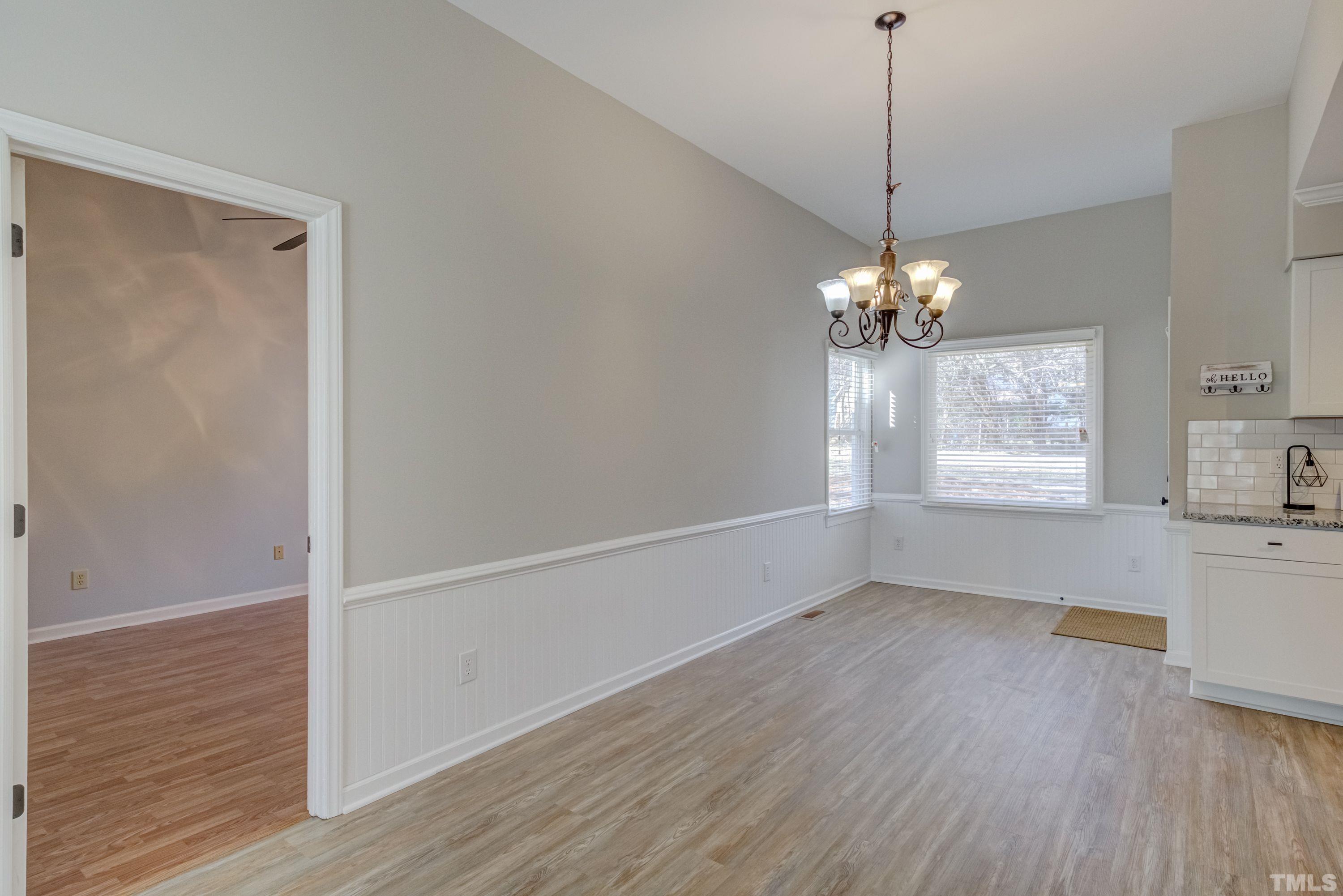 9305 Tallgrass Road Raleigh, NC 27603 - Photo 18 of 49 a view of an empty room with wooden floor and a window