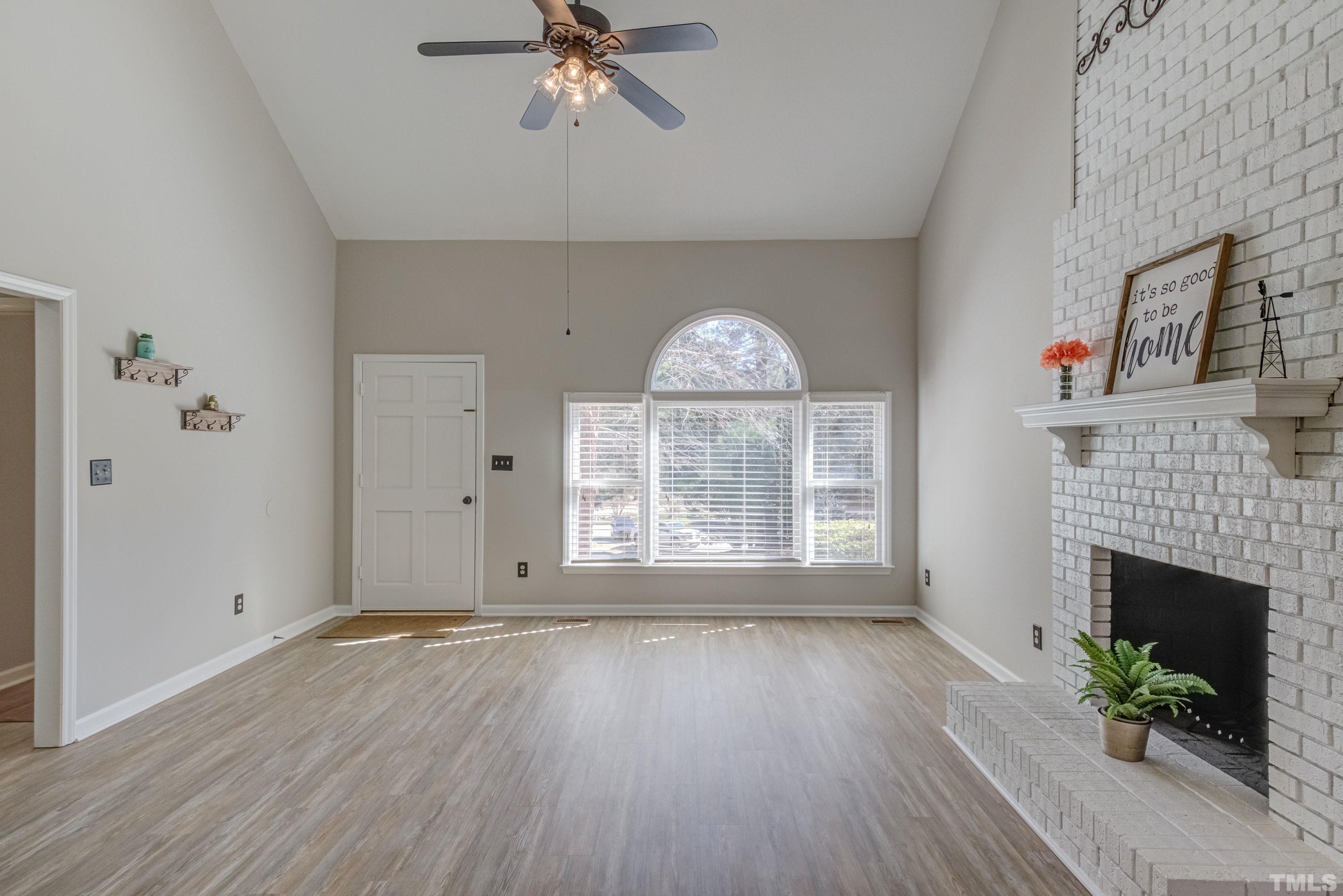 9305 Tallgrass Road Raleigh, NC 27603 - Photo 19 of 49 an empty room with windows and fireplace