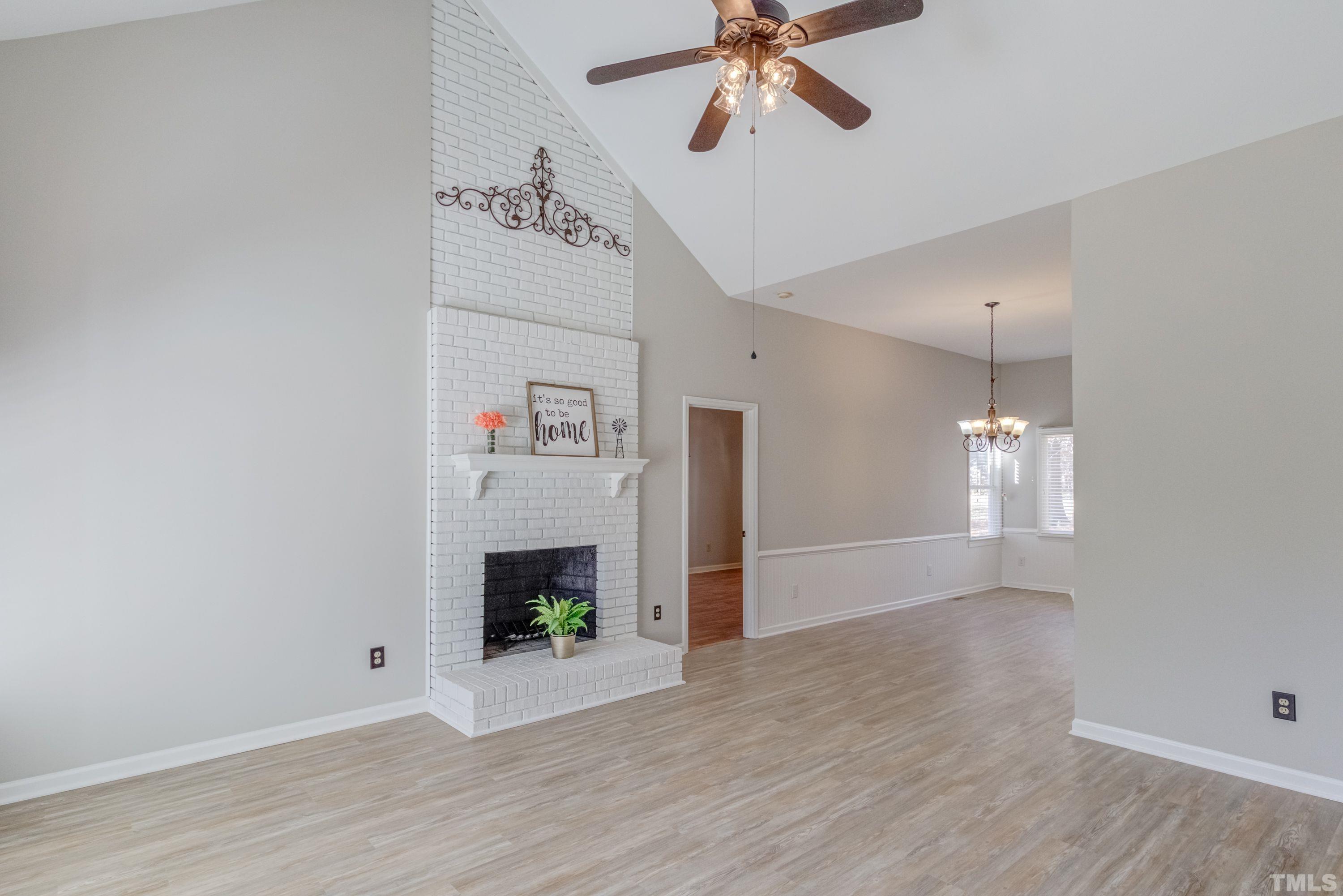 9305 Tallgrass Road Raleigh, NC 27603 - Photo 21 of 49 a view of an empty room with a fireplace and a fan