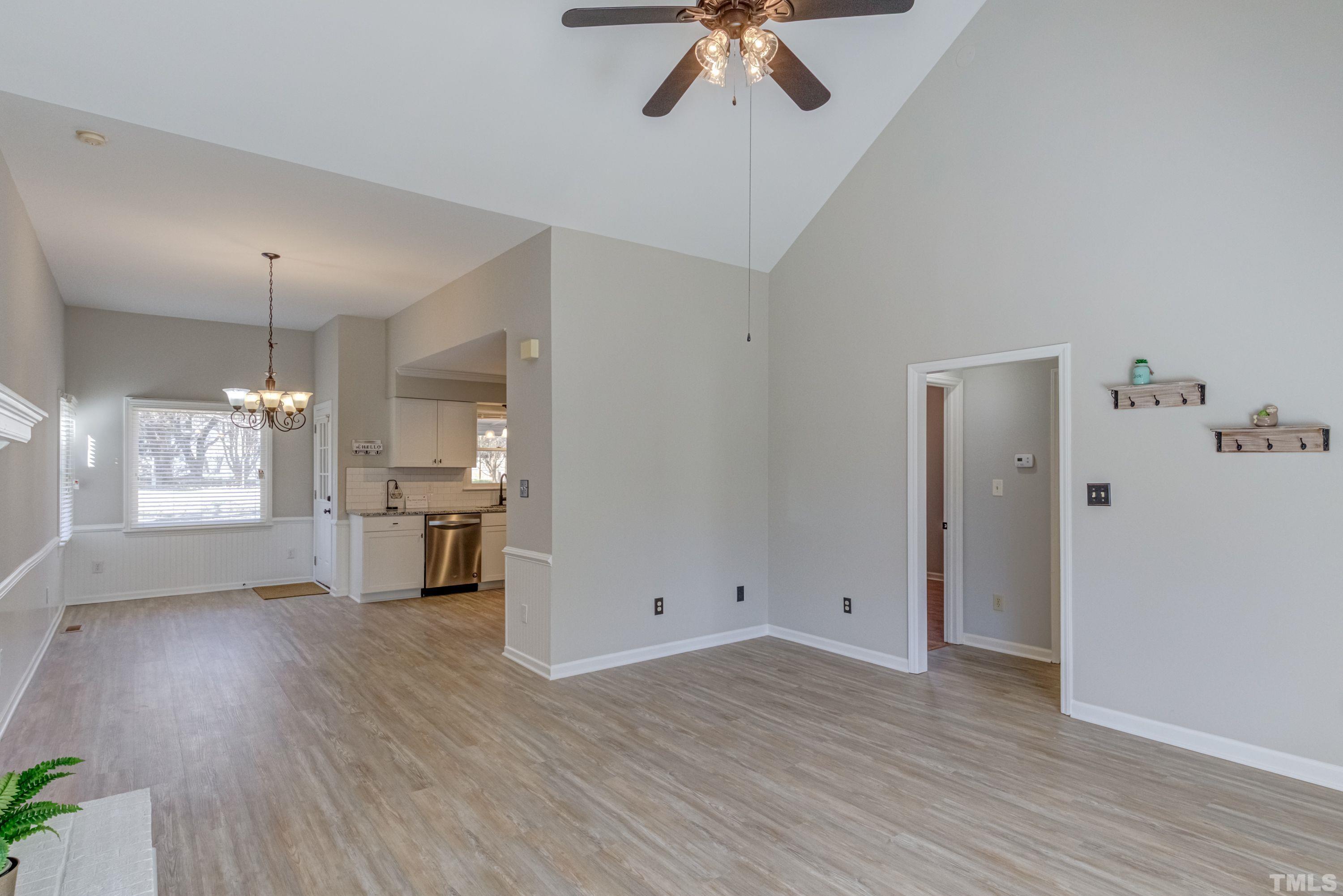 9305 Tallgrass Road Raleigh, NC 27603 - Photo 23 of 49 a view of empty room with wooden floor and window