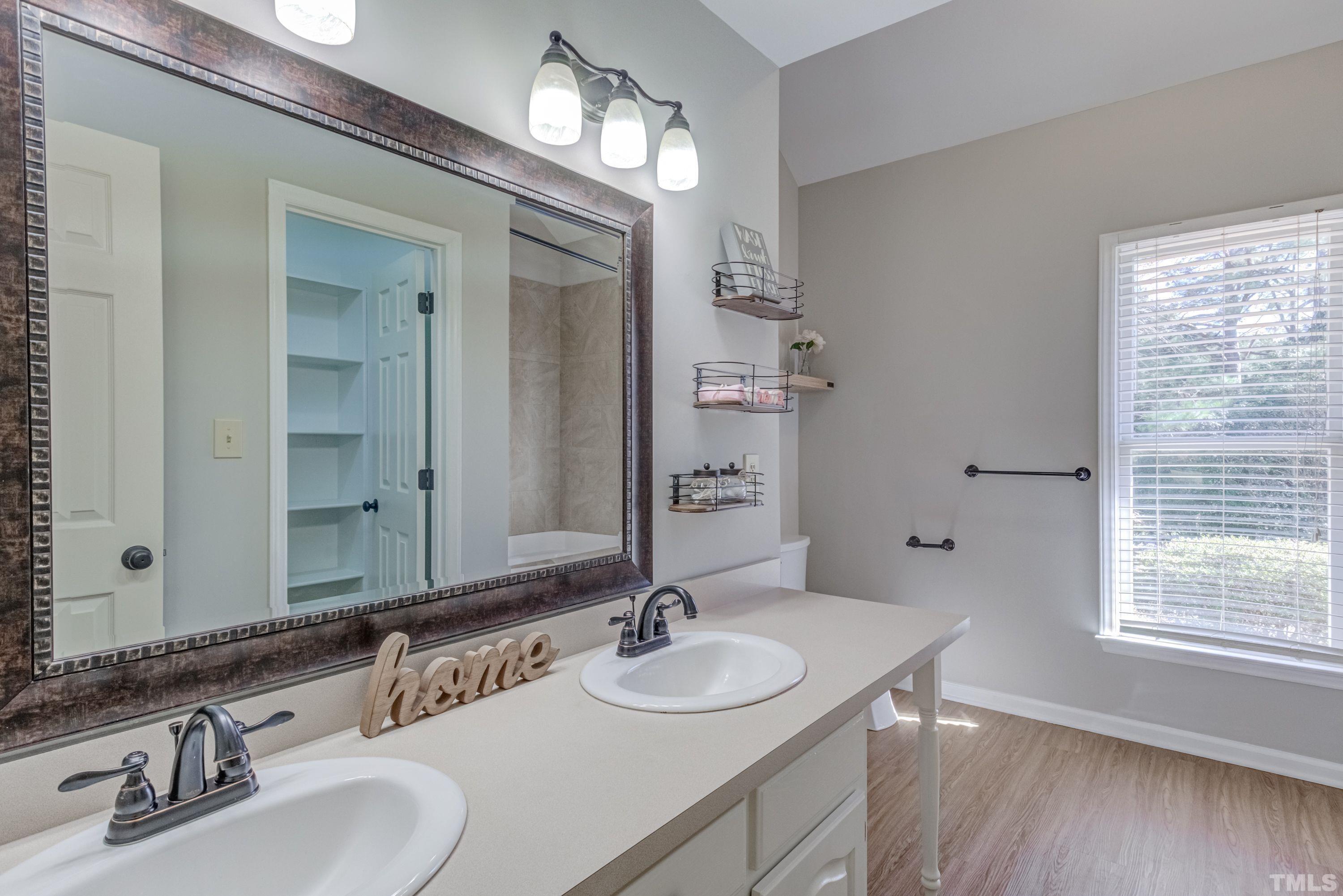 9305 Tallgrass Road Raleigh, NC 27603 - Photo 29 of 49 a bathroom with double vanity sinks and a mirror