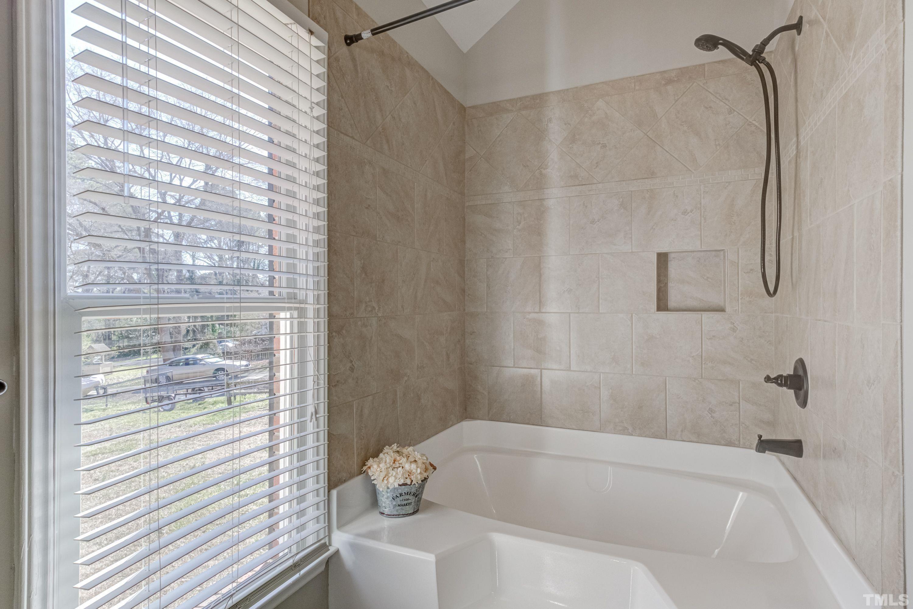 9305 Tallgrass Road Raleigh, NC 27603 - Photo 30 of 49 a bathroom with a bathtub and shower