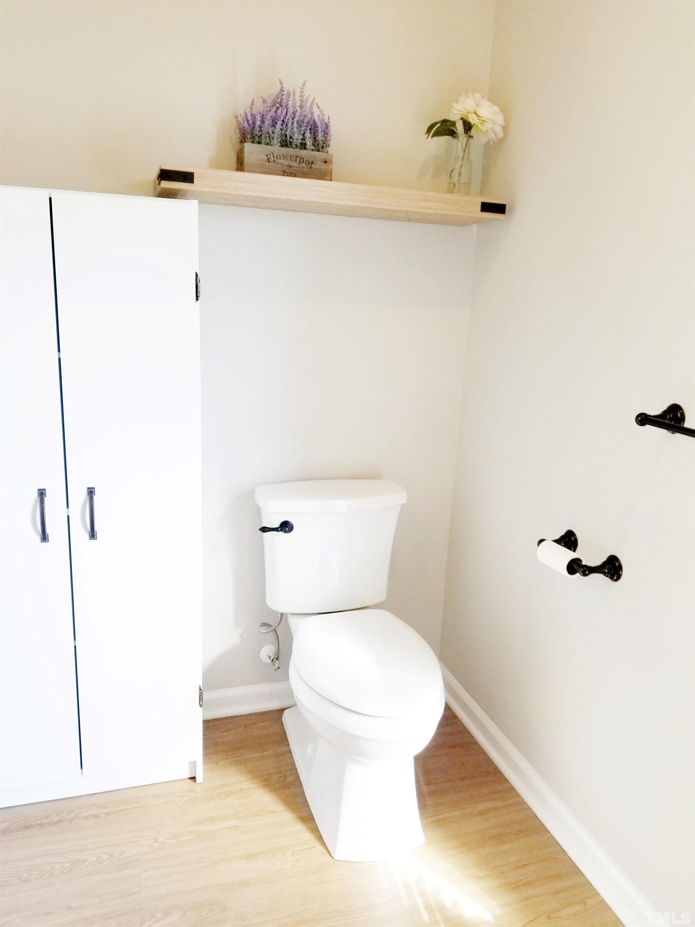 9305 Tallgrass Road Raleigh, NC 27603 - Photo 33 of 49 a white toilet sitting next to a bathroom sink
