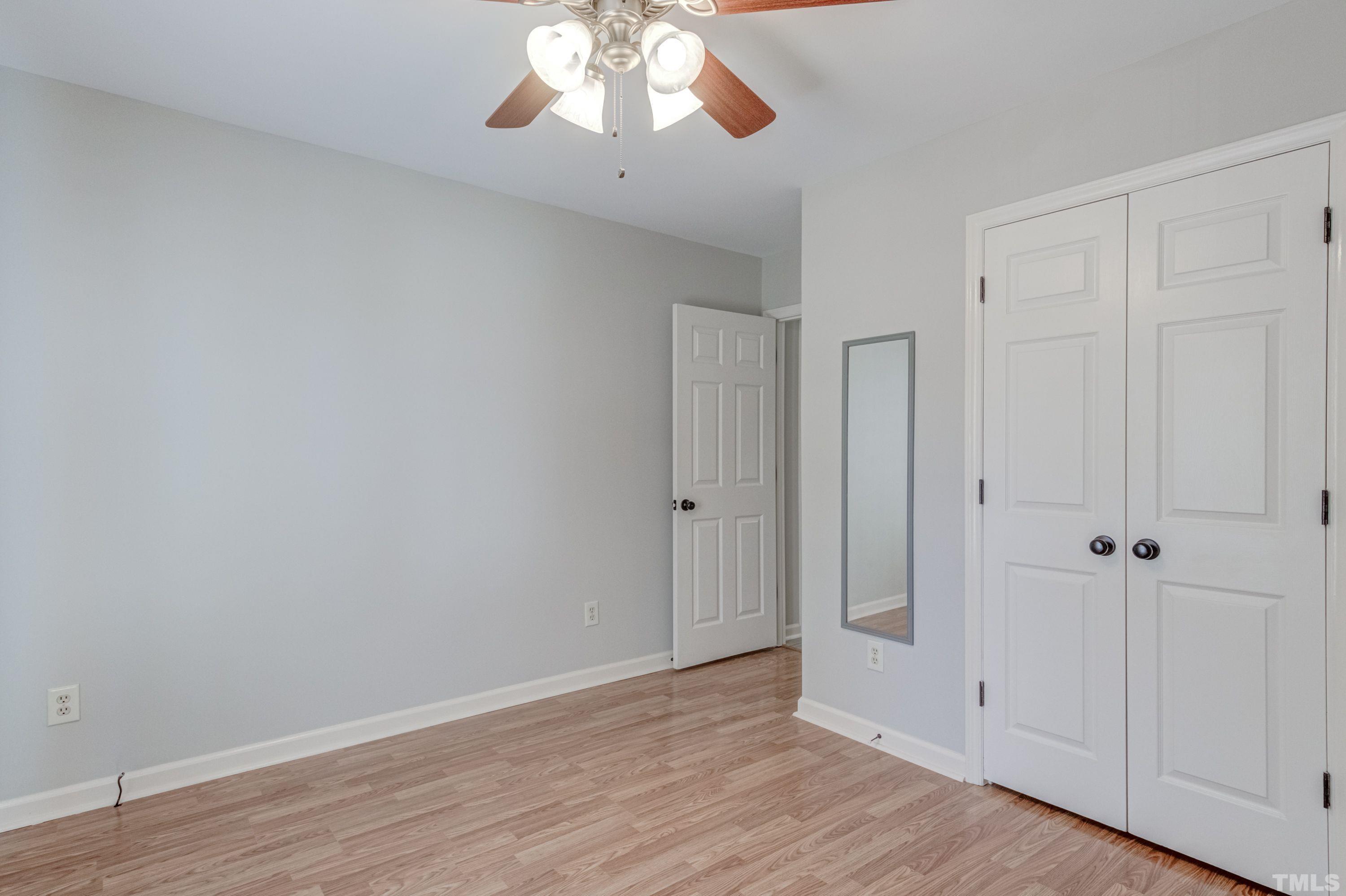 9305 Tallgrass Road Raleigh, NC 27603 - Photo 40 of 49 a view of an empty room with wooden floor