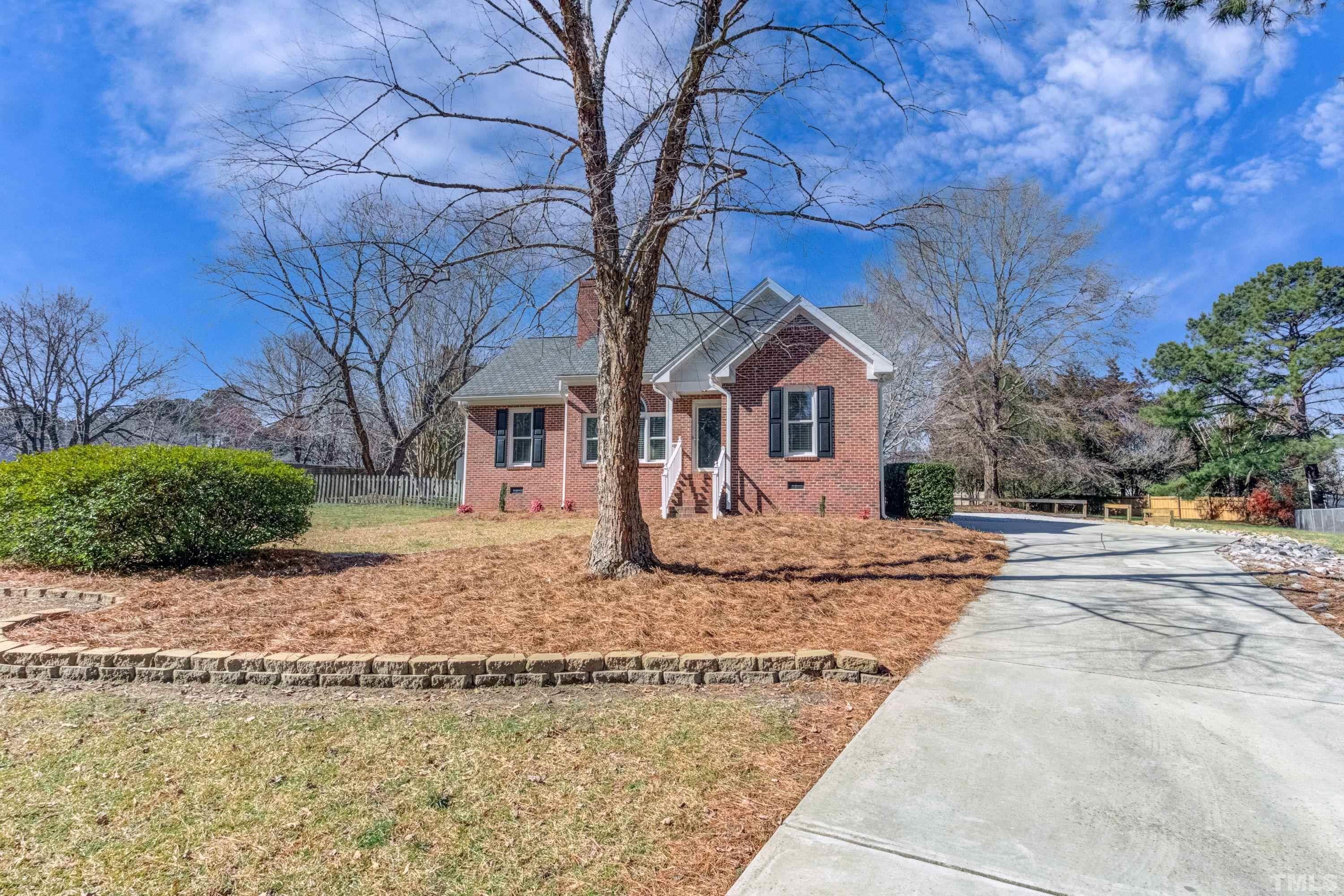 9305 Tallgrass Road Raleigh, NC 27603 - Photo 4 of 49 a front view of a house with garden