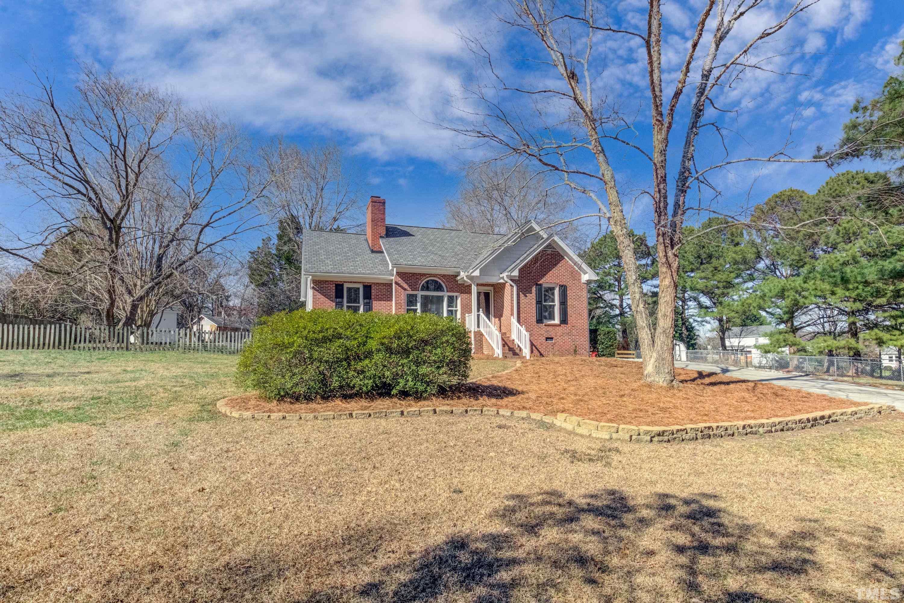 9305 Tallgrass Road Raleigh, NC 27603 - Photo 6 of 49 a front view of a house with a yard