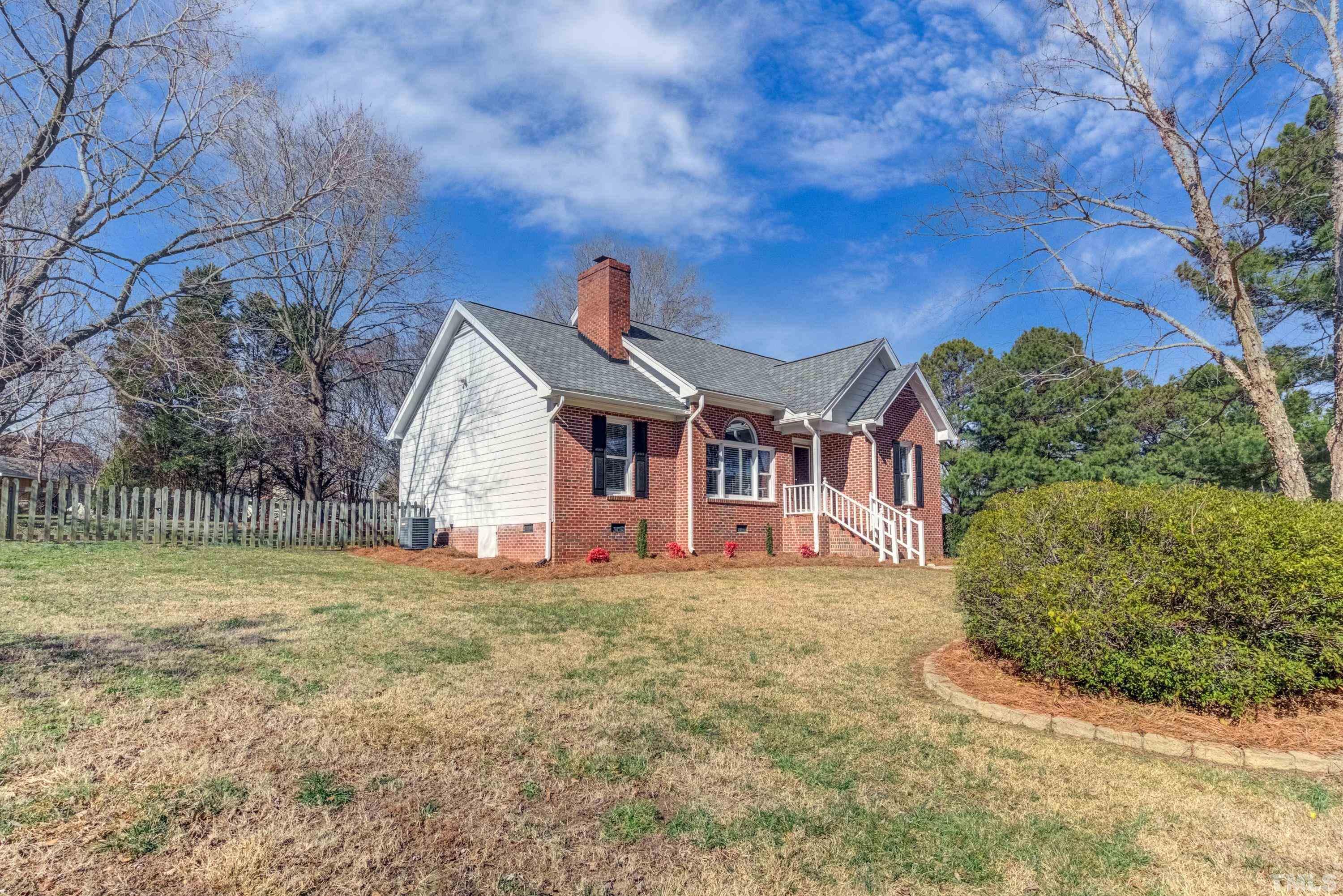 9305 Tallgrass Road Raleigh, NC 27603 - Photo 10 of 49 a front view of a house with a yard