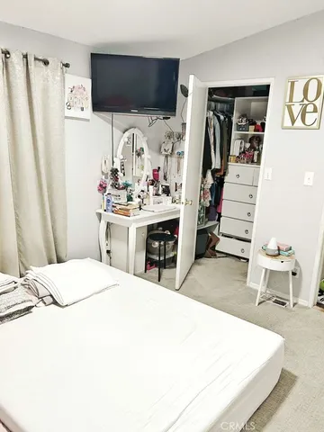 a room with a bed and a flat screen tv