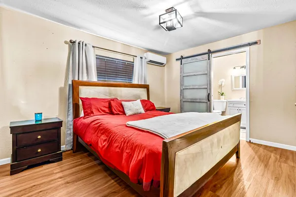 a bedroom with a bed and a dresser