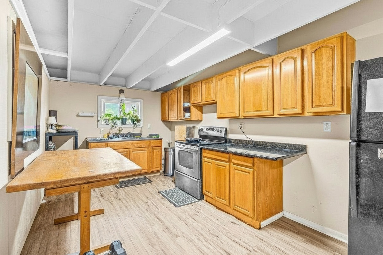 4806 Iiwi Road Kapaa, HI 96746 - Photo 27 of 30 a kitchen with stainless steel appliances granite countertop wooden cabinets a sink and a stove