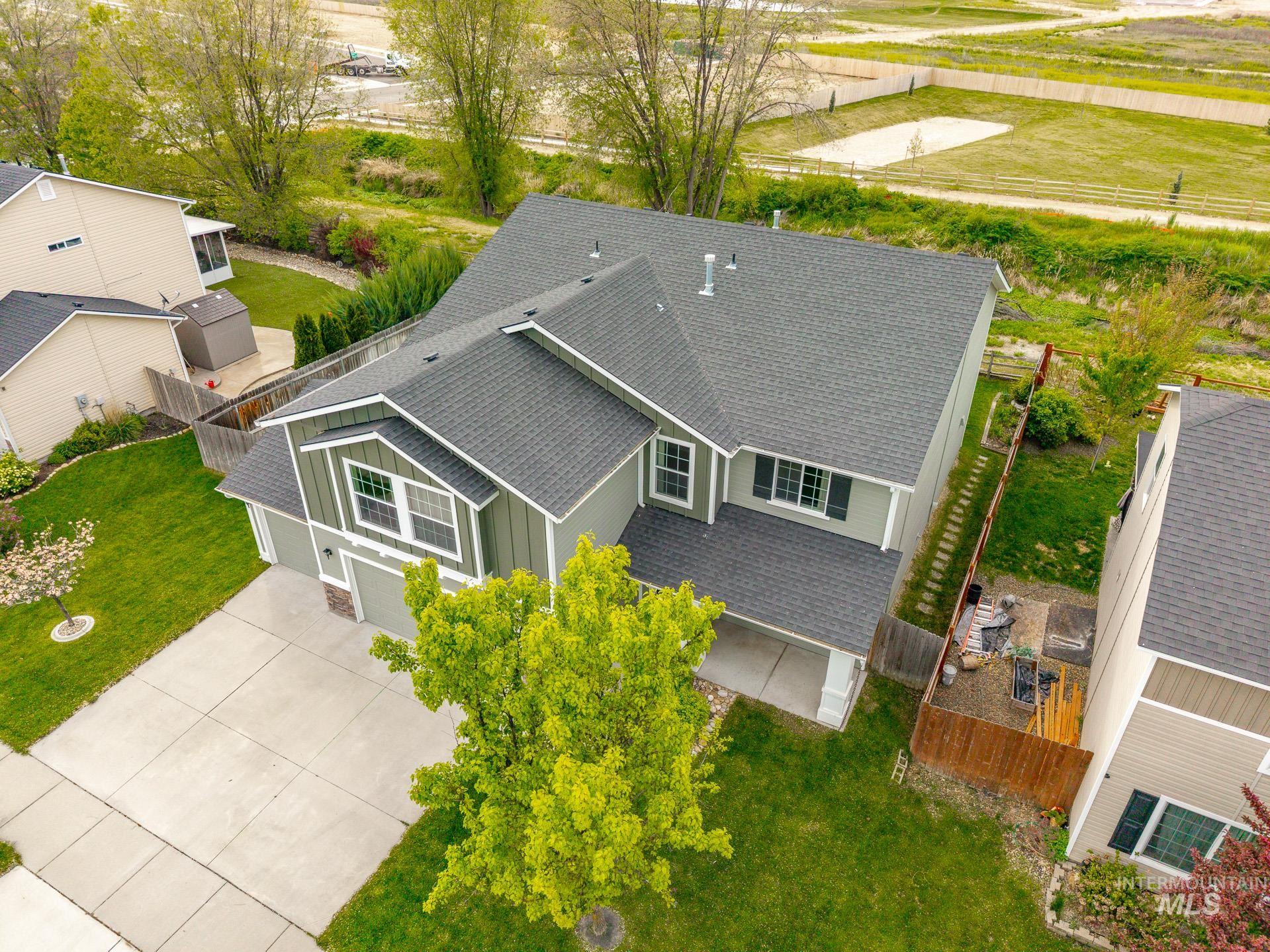 1555 Condor Drive Middleton, ID 83644 - Photo 2 of 50 Two-story residence featuring a gray shingle roof, green siding, and white trim accents