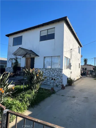 a view of a house with a yard and sitting area