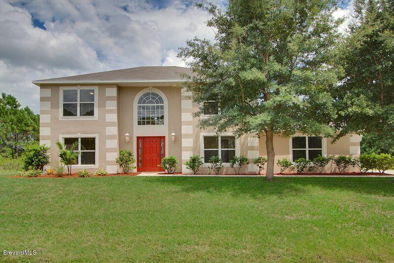 2139 Watkins Road Southeast Palm Bay, FL 32909 - Photo 1 of 32 a front view of house with yard and green space