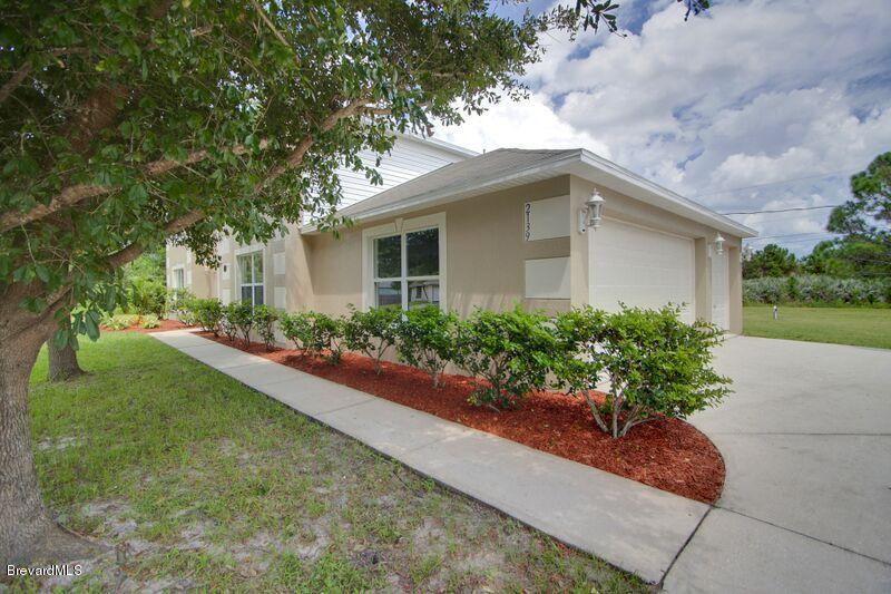 2139 Watkins Road Southeast Palm Bay, FL 32909 - Photo 2 of 32 a front view of a house with garden
