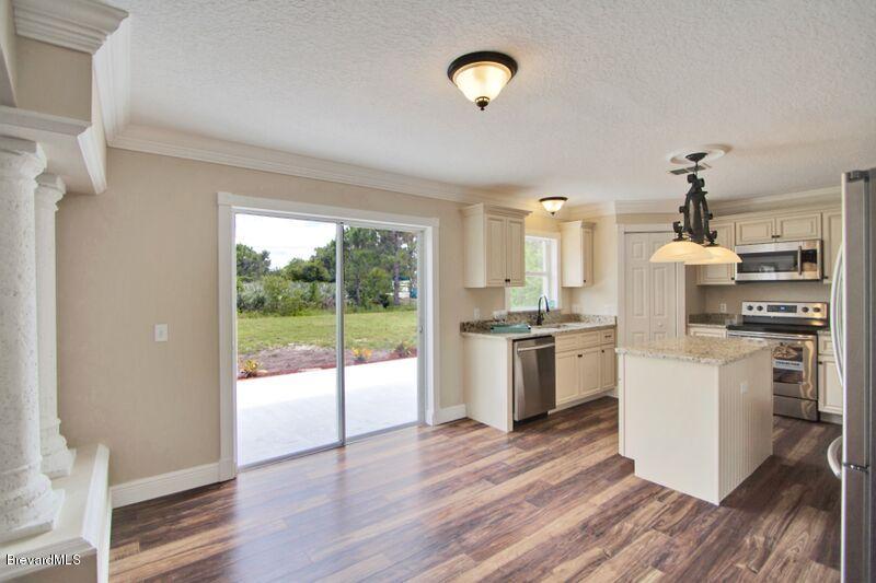 2139 Watkins Road Southeast Palm Bay, FL 32909 - Photo 11 of 32 a kitchen with a refrigerator and a stove top oven