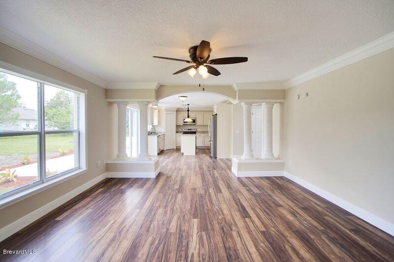2139 Watkins Road Southeast Palm Bay, FL 32909 - Photo 13 of 32 a view of a room with wooden floor window and a kitchen view