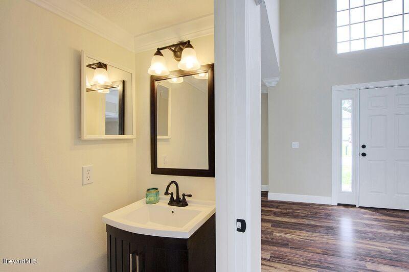 2139 Watkins Road Southeast Palm Bay, FL 32909 - Photo 14 of 32 a bathroom with a sink and a mirror