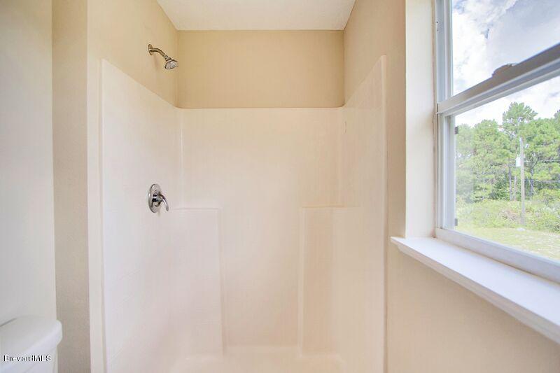 2139 Watkins Road Southeast Palm Bay, FL 32909 - Photo 18 of 32 a bathroom with a window and a shower
