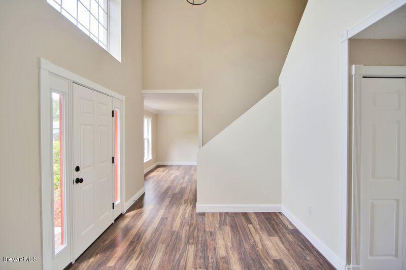 2139 Watkins Road Southeast Palm Bay, FL 32909 - Photo 3 of 32 a view of a hallway with wooden floor and entryway