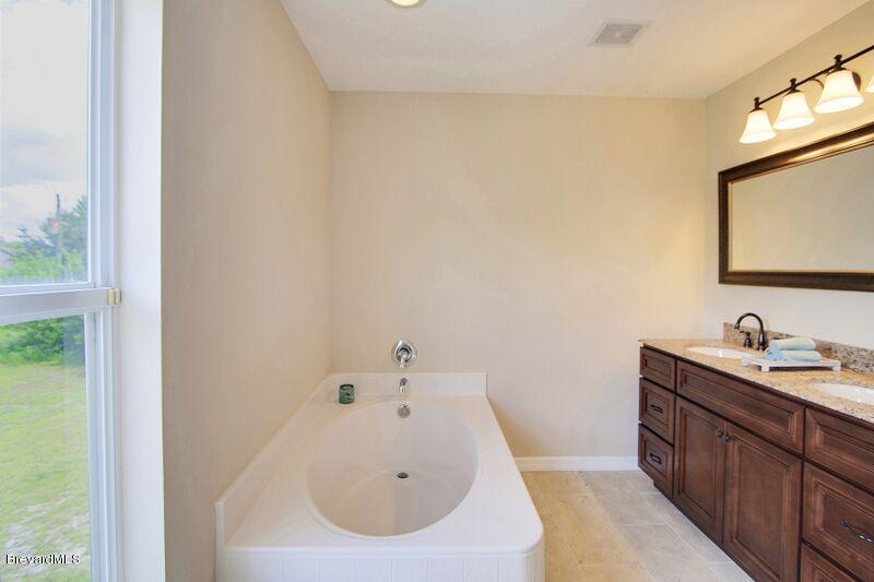 2139 Watkins Road Southeast Palm Bay, FL 32909 - Photo 20 of 32 a bathroom with a sink and a mirror