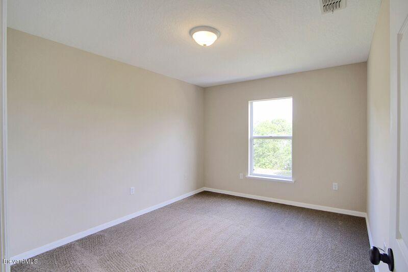 2139 Watkins Road Southeast Palm Bay, FL 32909 - Photo 21 of 32 an empty room with a window