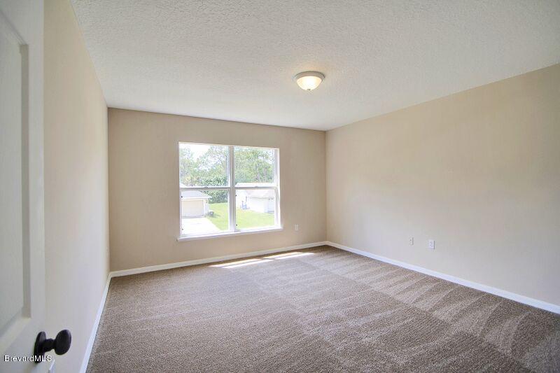 2139 Watkins Road Southeast Palm Bay, FL 32909 - Photo 22 of 32 an empty room with a window