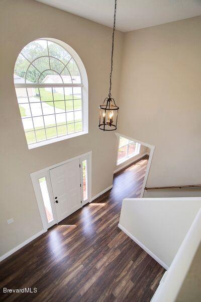 2139 Watkins Road Southeast Palm Bay, FL 32909 - Photo 26 of 32 a view of an empty room with wooden floor and a window
