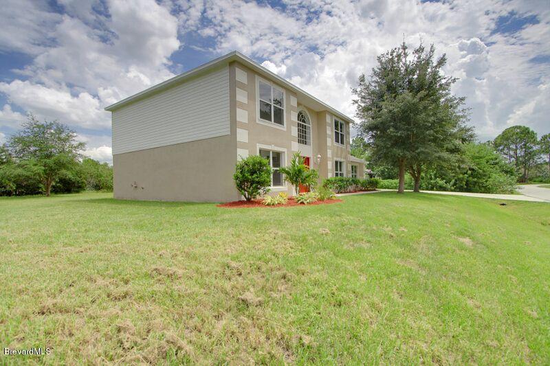 2139 Watkins Road Southeast Palm Bay, FL 32909 - Photo 28 of 32 a front view of house with yard and green space