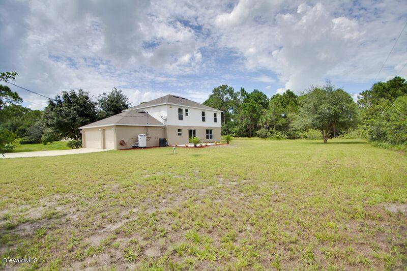 2139 Watkins Road Southeast Palm Bay, FL 32909 - Photo 29 of 32 a front view of a house with a yard