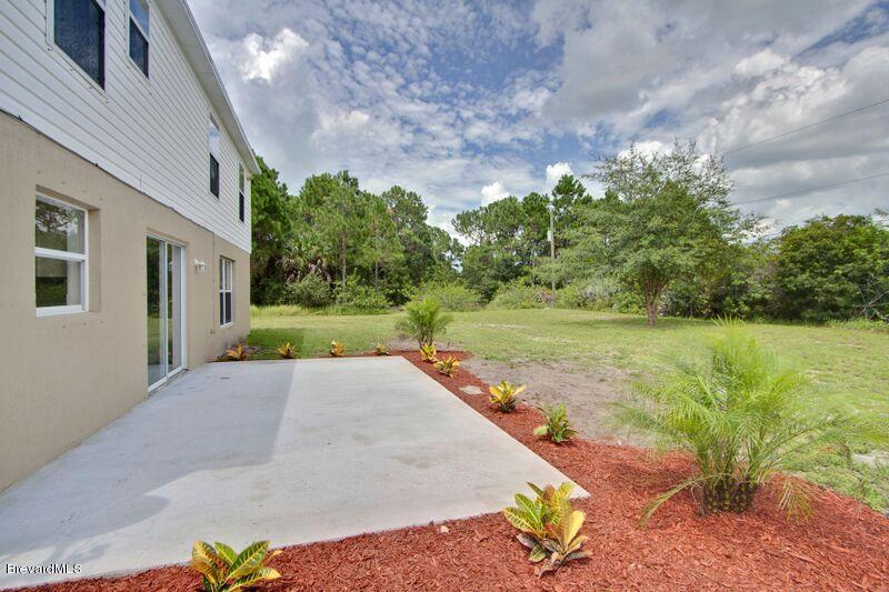 2139 Watkins Road Southeast Palm Bay, FL 32909 - Photo 31 of 32 a view of a backyard with plants and lake view