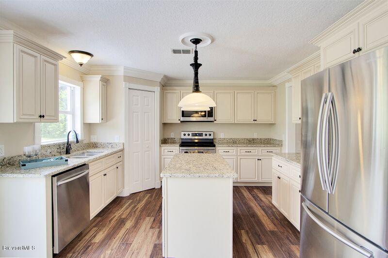 2139 Watkins Road Southeast Palm Bay, FL 32909 - Photo 8 of 32 a kitchen with a refrigerator and a stove