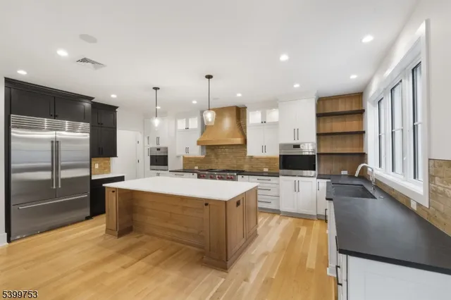 a kitchen with granite countertop a stove a sink and a granite counter tops