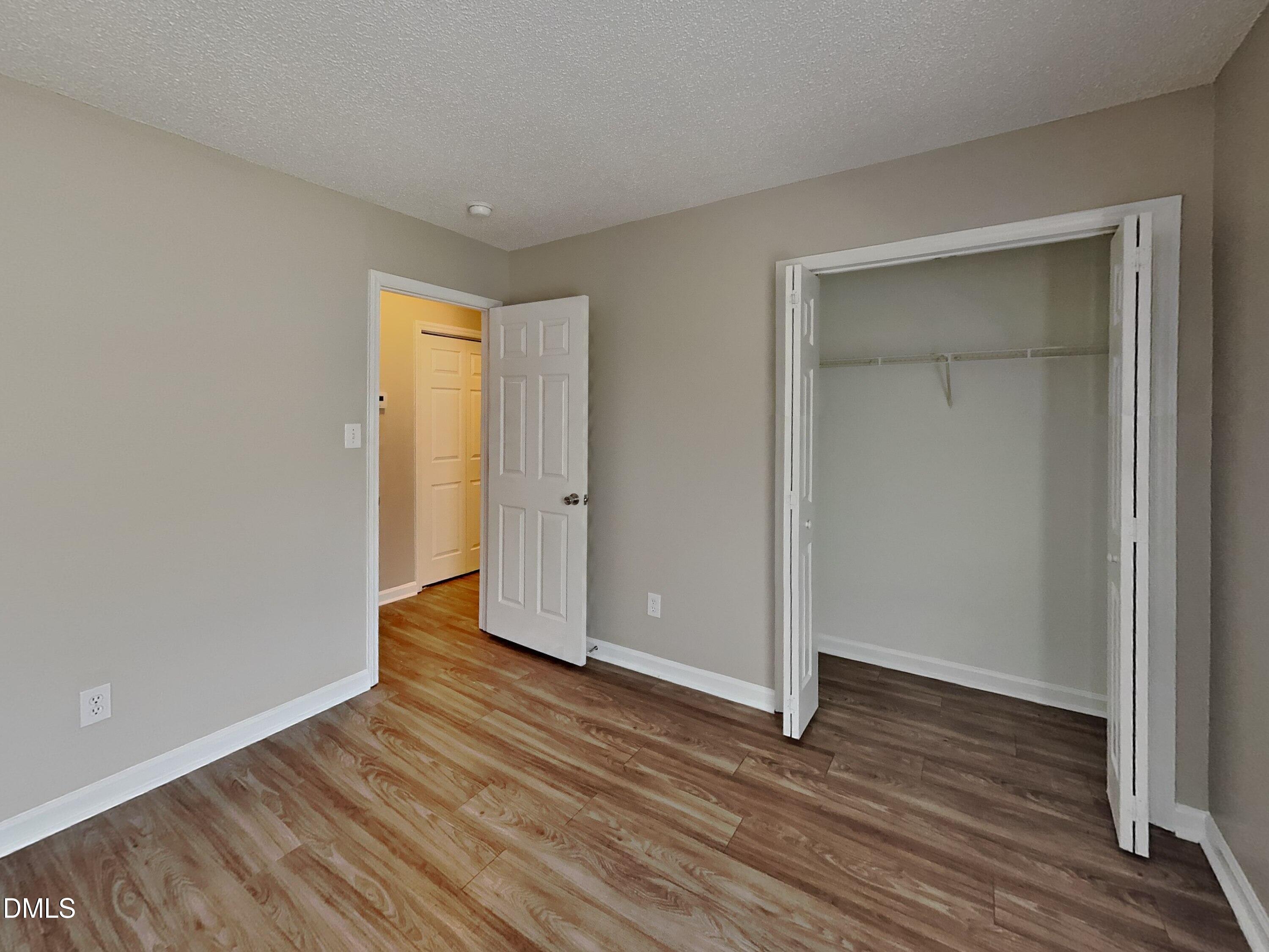5516 Wilhagan Court Raleigh, NC 27616 - Photo 12 of 16 a view of an empty room with wooden floor and closet