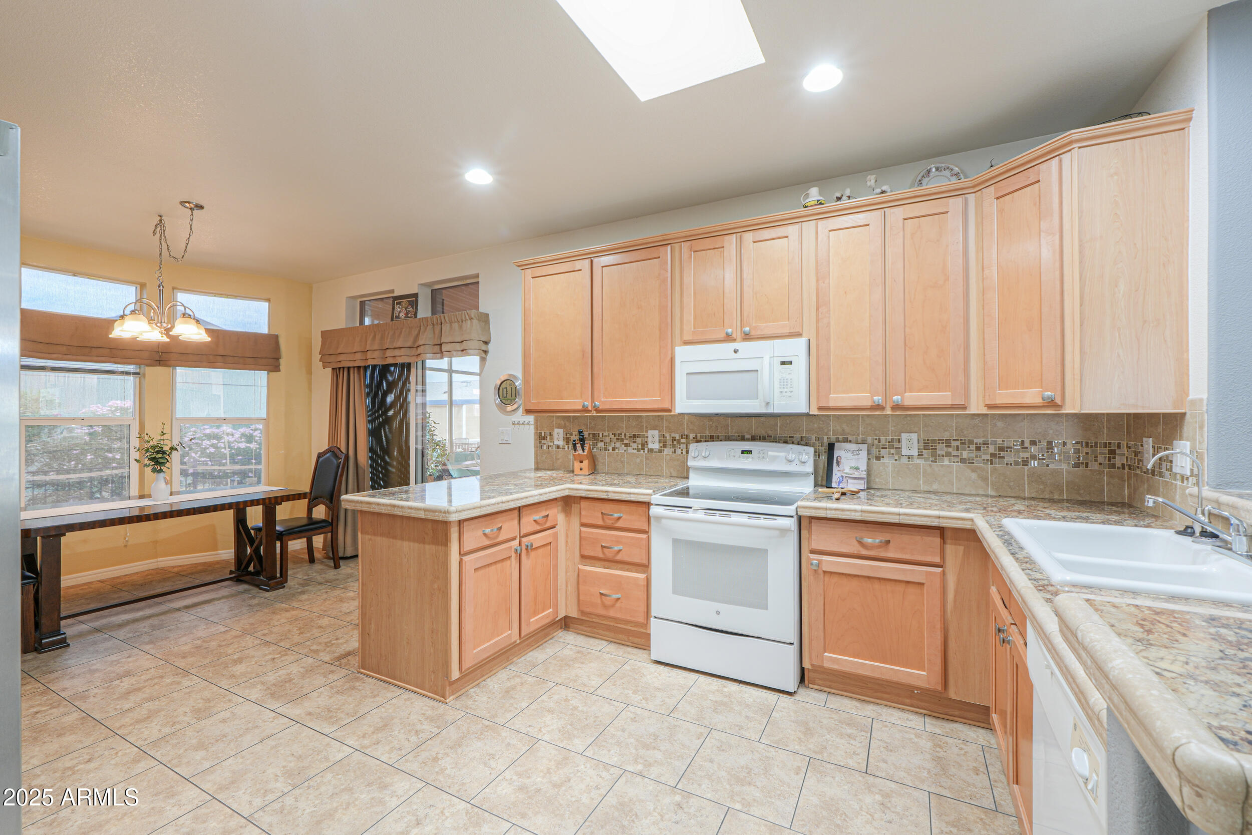 2263 North Trekell Road, Unit 36 Casa Grande, AZ 85122 - Photo 11 of 53 a kitchen with a stove sink and cabinets